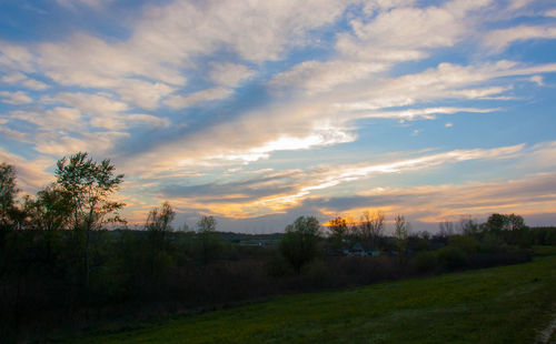 Scenic view of field against sky during sunset