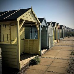 Row of beach houses on beach against clear sky