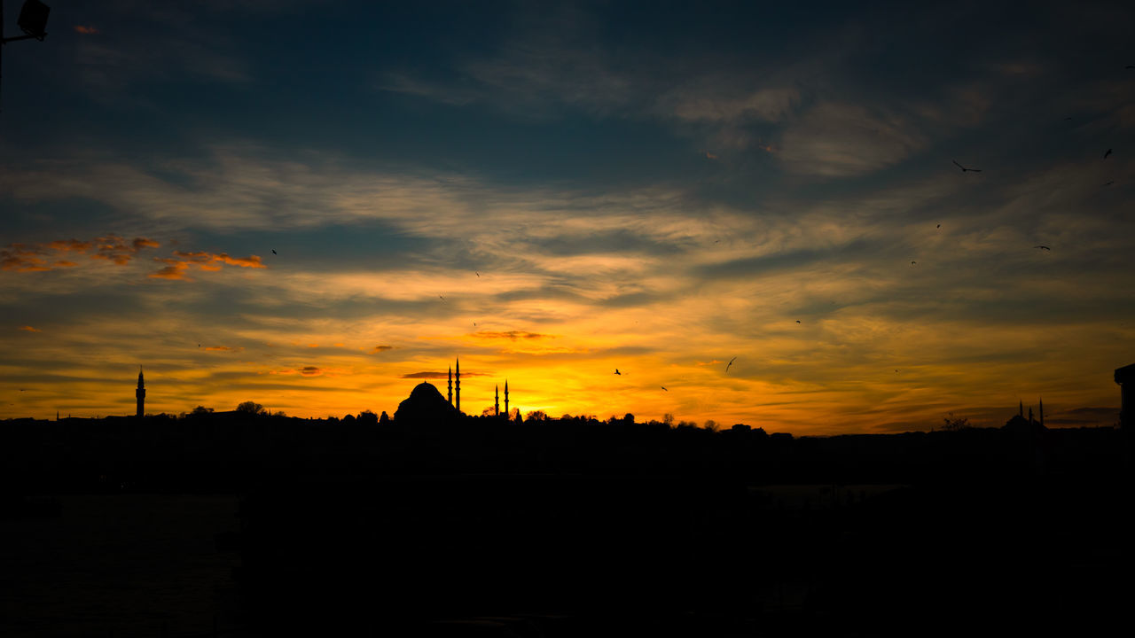 SILHOUETTE BUILDINGS AGAINST SKY AT SUNSET