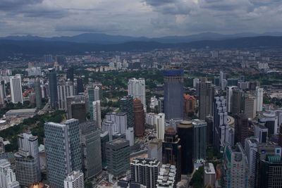 Cityscape against cloudy sky