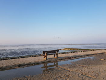 Scenic view of beach against clear sky