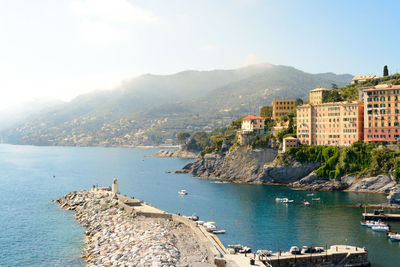 Panoramic view of sea and buildings against sky