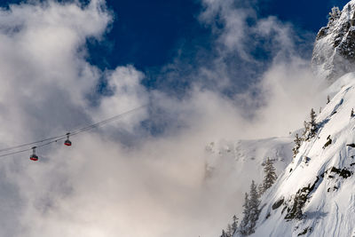 Low angle view of snowcapped mountain against sky