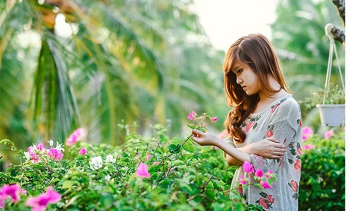 plant, women, flower, flowering plant, one person, nature, adult, beauty in nature, growth, long hair, lifestyles, freshness, young adult, hairstyle, summer, female, gardening, smiling, springtime, lawn, looking, happiness, green, garden, outdoors, spring, leisure activity, holding, environment, child, agriculture, casual clothing, land, brown hair, looking down, field, environmental conservation, floristry, emotion, landscape, side view, meadow, ornamental garden, childhood, grass, greenhouse, selective focus, standing, botany, flowerbed, day, person, portrait, relaxation