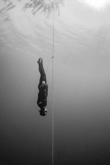 PERSON FISHING AT SEA SHORE