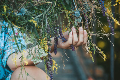 Midsection of woman holding plant