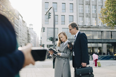 Couple holding mobile phone in city