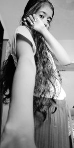 Portrait of young woman looking at home