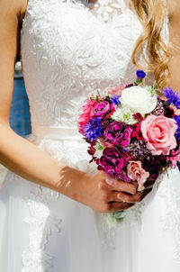 Midsection of woman holding flower bouquet