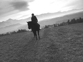 Rear view of man on mountains against sky