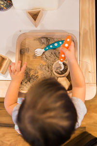 High angle view of boy playing on table at home