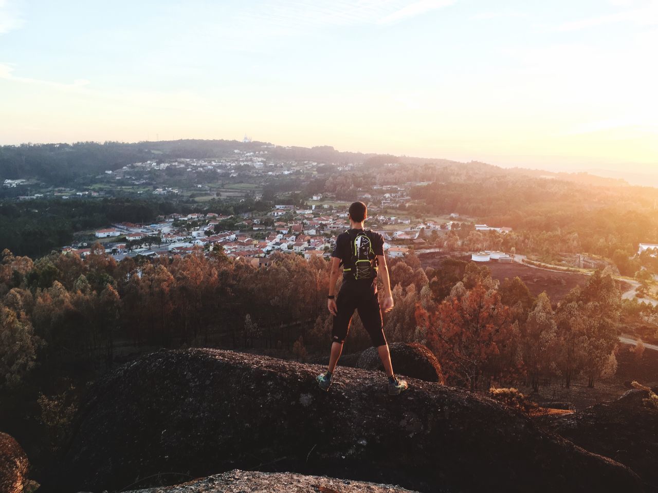 rear view, leisure activity, full length, mountain, men, standing, lifestyles, shadow, city, sky, cityscape, mountain range, scenics, cloud - sky, beauty in nature, remote, tranquil scene, nature, day, sunbeam, outdoors, tranquility