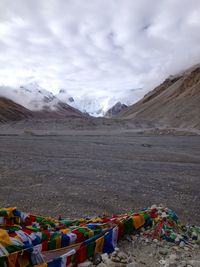 Scenic view of mountains against cloudy sky