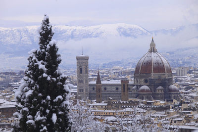 Florence cathedral in city against sky during winter