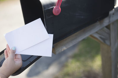 Close-up of hand holding paper