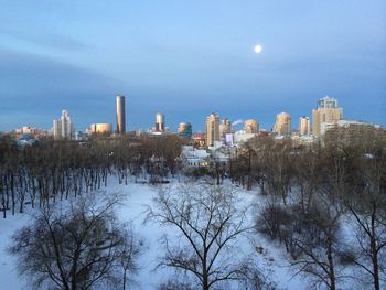 Panoramic view of city during winter against sky