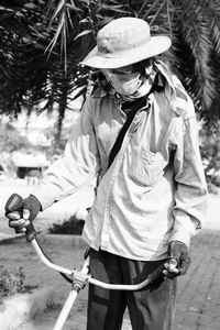 Man wearing hat working outdoors