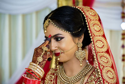 Close-up of bride getting dressed