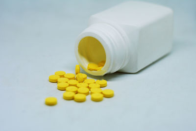 Close-up of yellow bottle on table