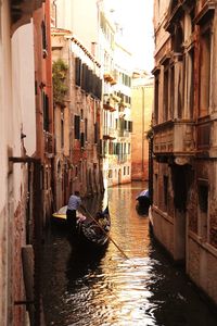 Boats in river with buildings in background