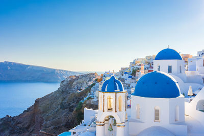 High angle view of santorini, oia townscape by sea against sky. cyclades, greek islands, greece