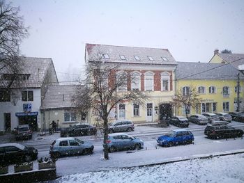 Buildings in city against sky during winter