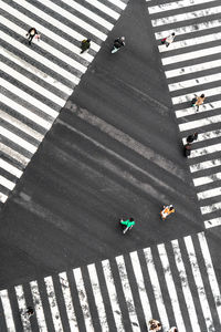 High angle view of people crossing road