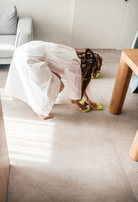 Woman lying on floor at home