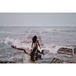 Full length of woman on beach against sky