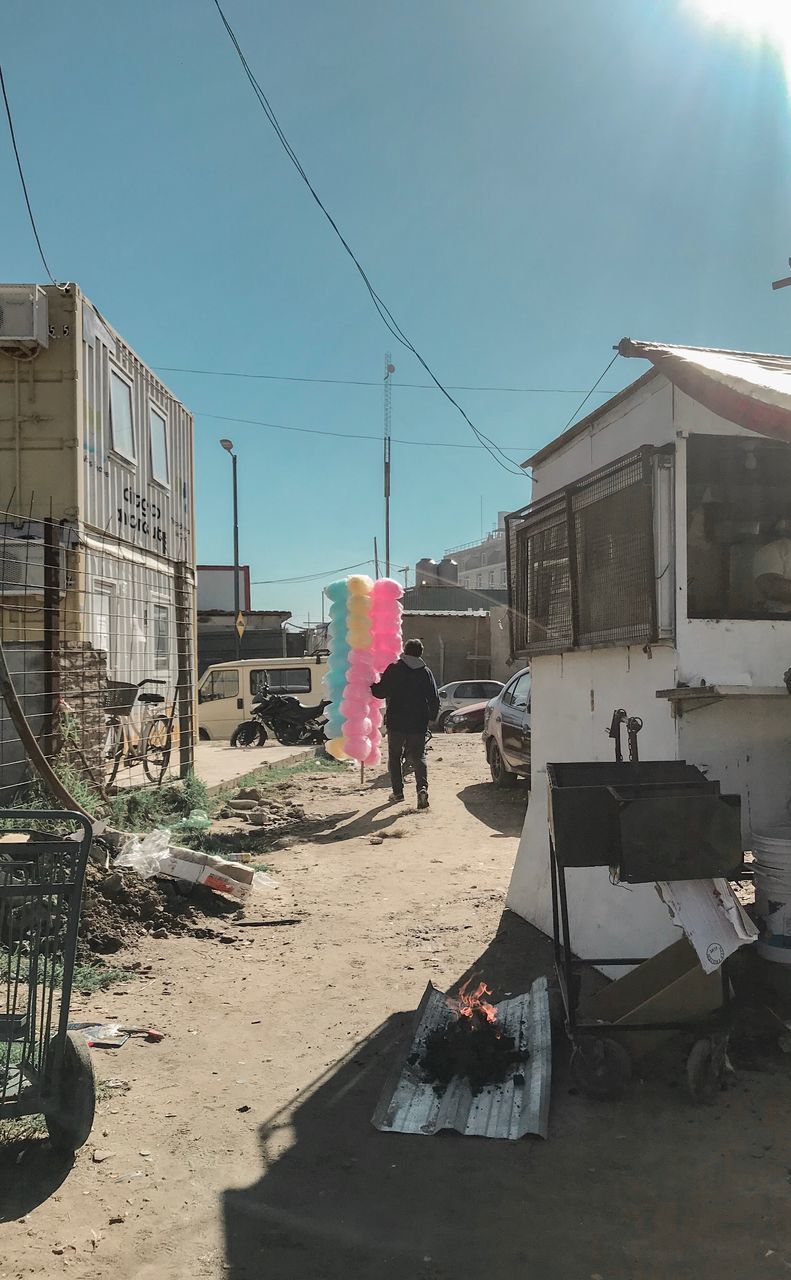 MAN WORKING ON BUILDING IN CITY