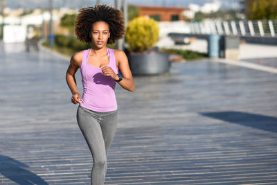 Woman running on footpath