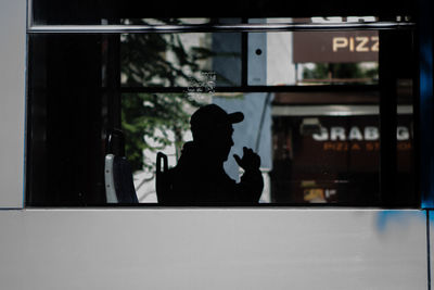Silhouette of man in glass window