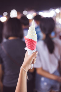Close-up of woman holding ice cream cone
