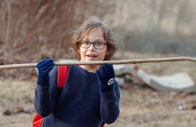 Portrait of boy holding stick