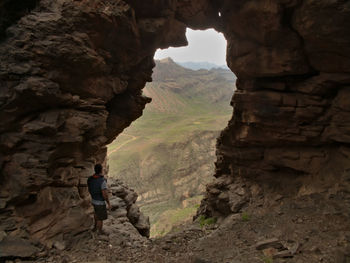 Man standing on rocks by mountain