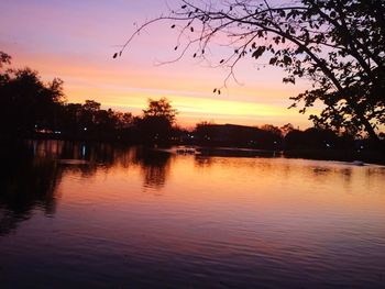 Scenic view of lake against sky at sunset