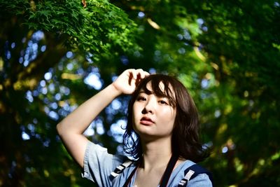 Portrait of teenage girl looking away in forest