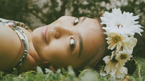 Close-up portrait of smiling woman with flowers tiara