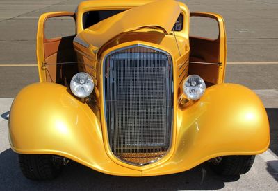 Close-up of old-fashioned yellow car
