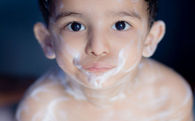 High angle portrait of boy with soap sud in bathtub