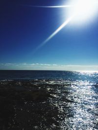 Scenic view of sea against blue sky