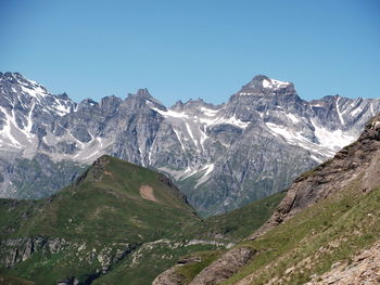 Scenic view of snowcapped mountains against clear blue sky