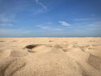 Scenic view of beach against blue sky