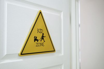 Close-up of warning sign on door