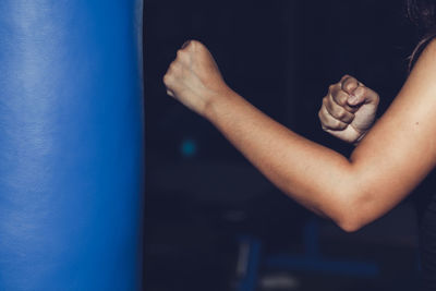 Close-up of person boxing on punching bag