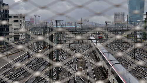 High angle view of railroad tracks amidst buildings in city