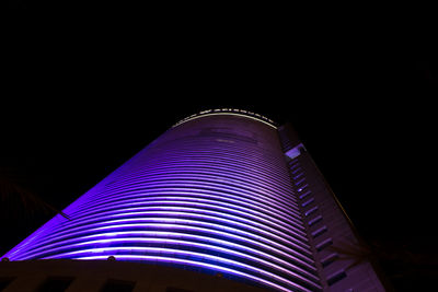 Low angle view of illuminated building at night