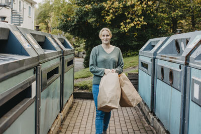 Woman recycling rubbish