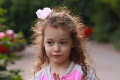 Portrait of cute girl with pink flower