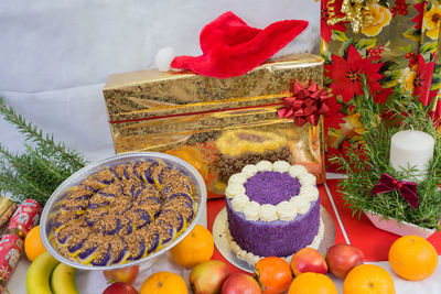 Close-up of food and gifts on table during christmas